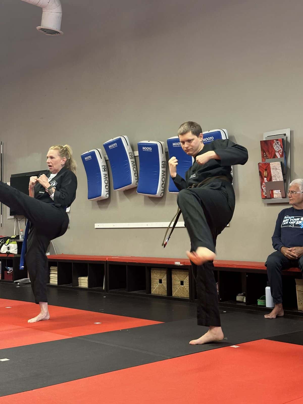Adult NEXTStep students practicing kicks
